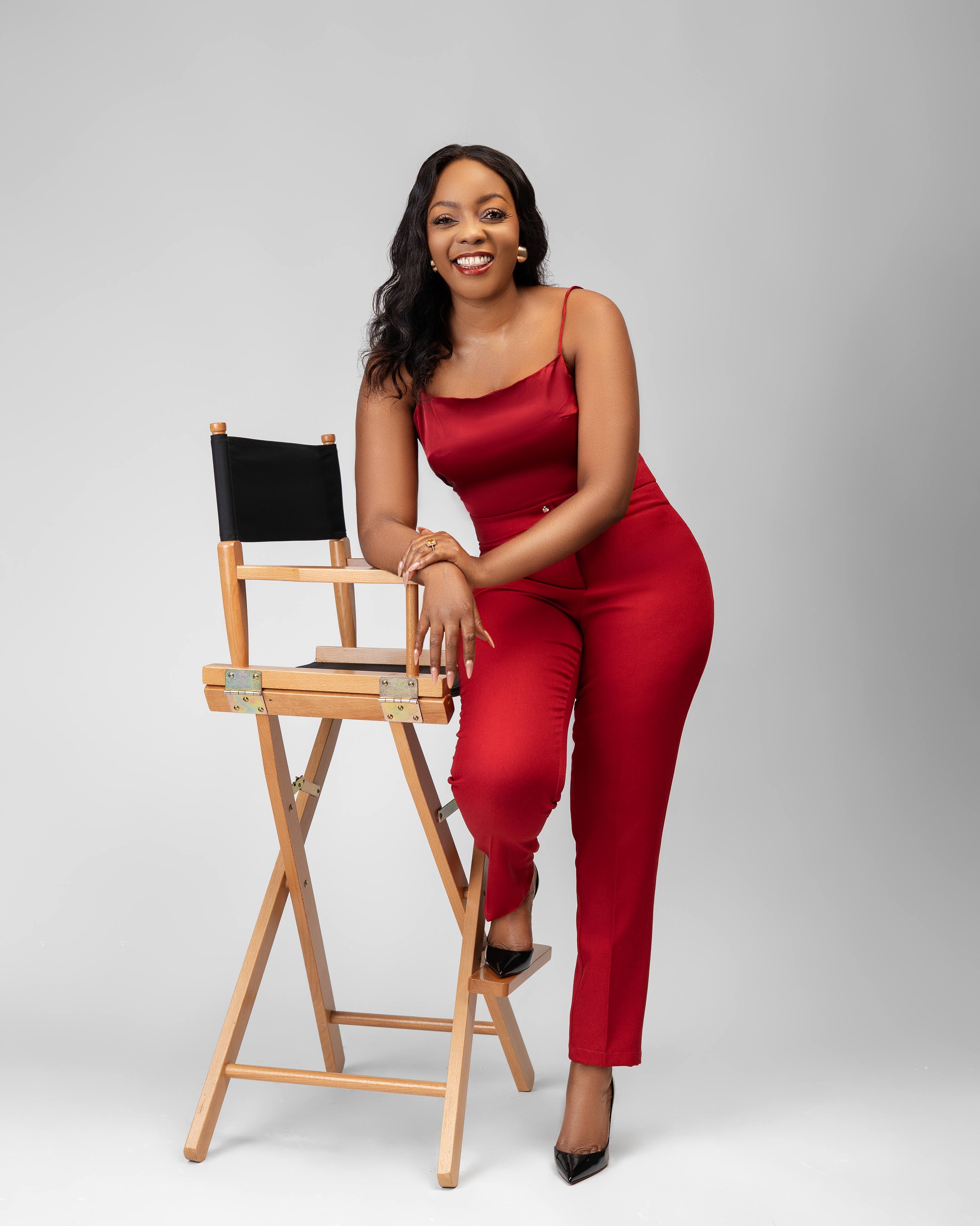 Cynthia Mwangi seated in signature red outfit